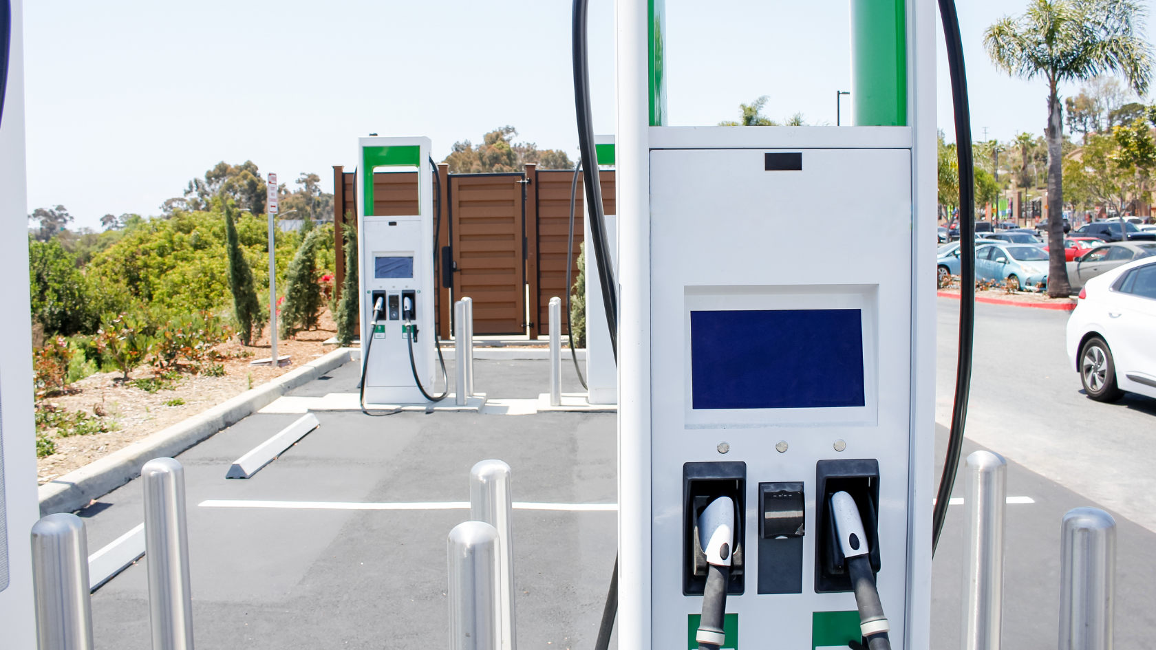 An electric car charging at a gas station